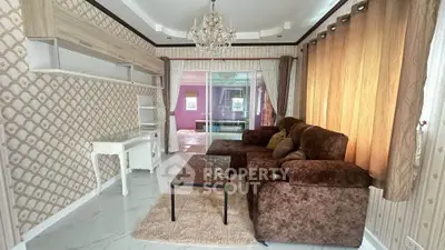 Elegant living room with plush brown sofa, chandelier, and stylish wallpaper, perfect for cozy gatherings.
