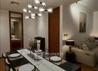 Elegant dining room with modern lighting and cozy living area