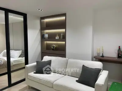 Modern living room with cozy sofa and elegant shelving, reflecting contemporary interior design.