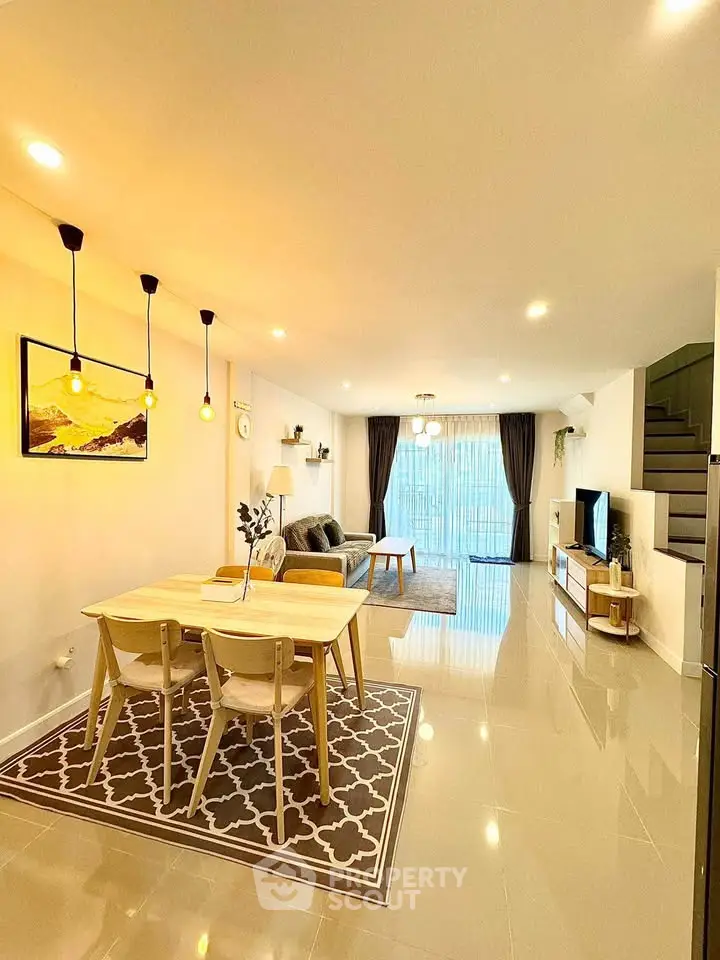 Spacious modern living room with elegant dining area and large windows for natural light.