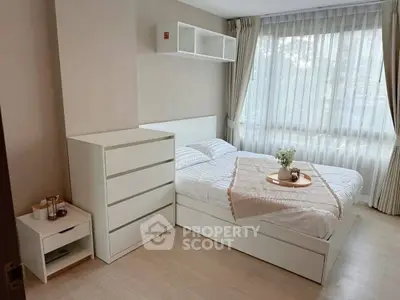 Bright and cozy bedroom with modern white furniture and large window