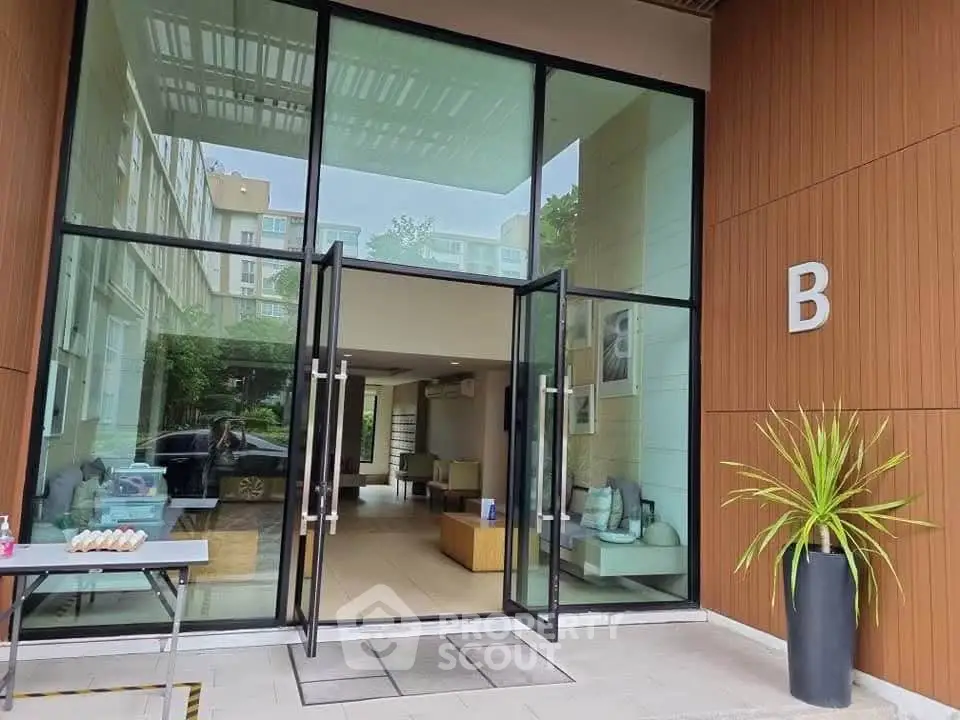 Modern building entrance with glass doors and stylish interior design