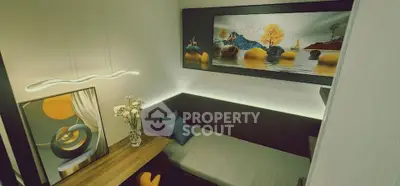 Stylish modern living room with artistic decor and cozy seating area.
