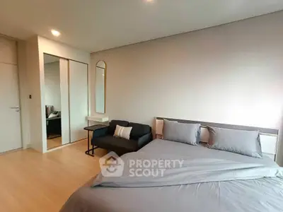 Modern bedroom with sleek design and mirrored closet doors