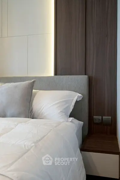 Modern bedroom with stylish headboard and cozy bedding