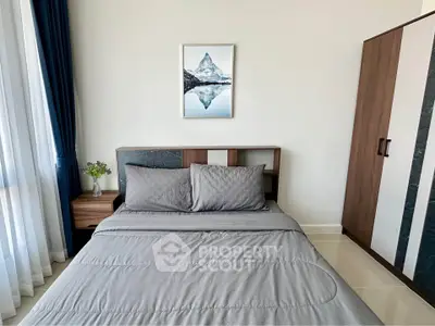 Modern bedroom with stylish decor and natural light, featuring a cozy bed and elegant wardrobe.