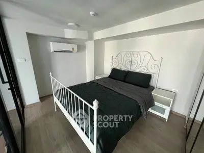 Modern bedroom with elegant metal bed frame and sleek wooden flooring