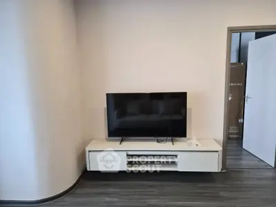 Modern living room with sleek TV stand and flat-screen television, perfect for entertainment.