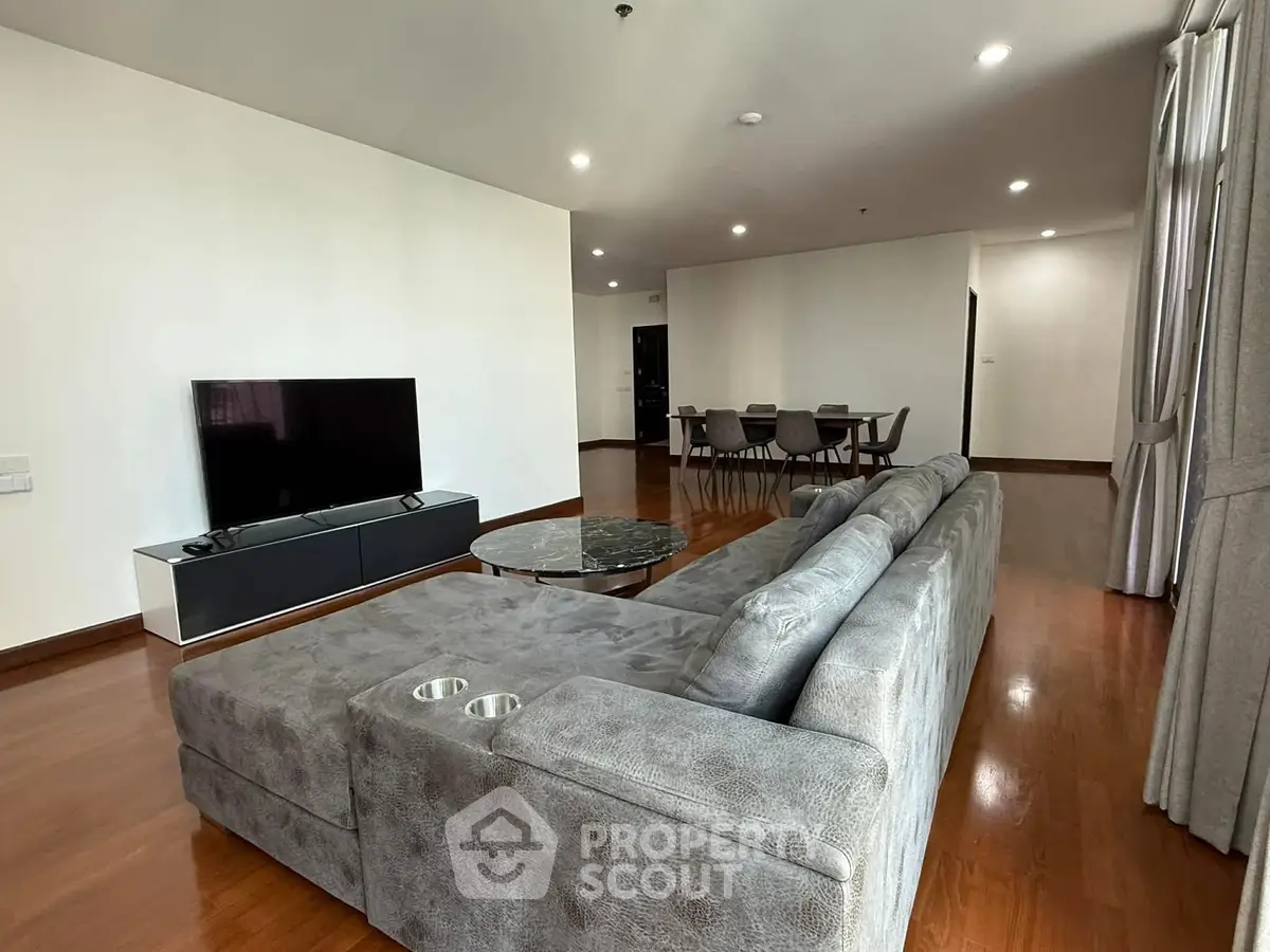 Spacious modern living room with sleek furniture and open dining area