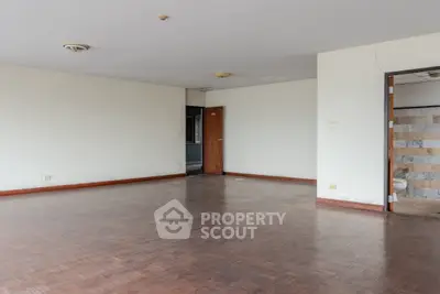 Spacious empty living room with wooden flooring and open doorway