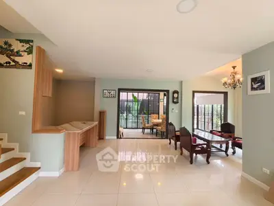 Spacious living room with elegant furniture and large windows offering natural light.