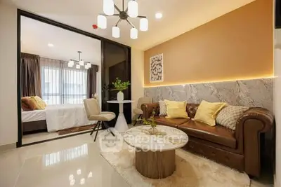 Stylish modern living room with elegant decor and cozy seating area, adjacent to a bright bedroom.