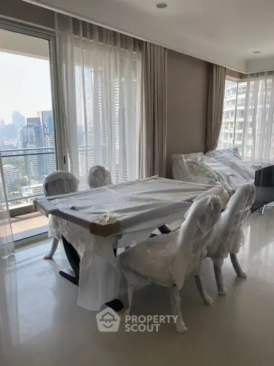 Spacious living room with city view and elegant dining setup in modern apartment