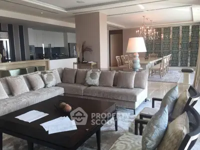 Luxurious open-plan living and dining area with elegant decor and plush seating.