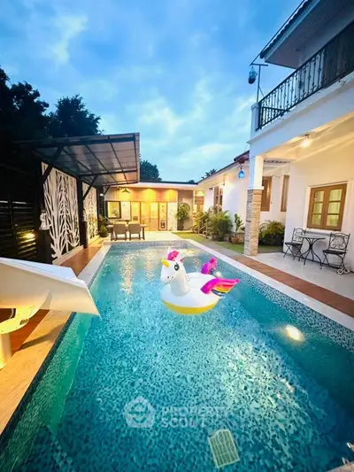 Luxurious villa with private pool and stylish outdoor seating area at dusk.
