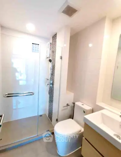 Modern bathroom with glass shower and sleek fixtures