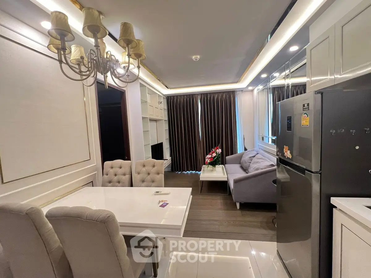 Modern living room with elegant dining area and cozy seating, featuring stylish lighting and contemporary decor.