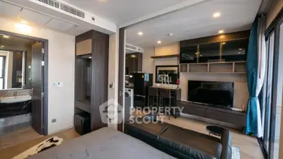 Modern living room with sleek design and open layout, featuring a cozy seating area and stylish entertainment center.