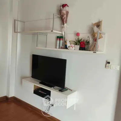 Modern living room with wall-mounted TV and decorative shelves