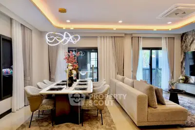Luxurious modern living room with elegant dining area and stylish lighting, perfect for entertaining guests.