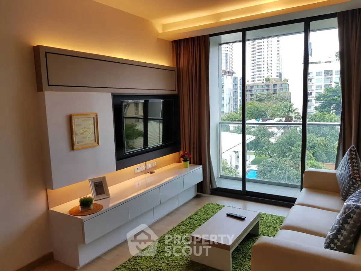 Modern living room with large window offering city view, stylish furniture, and vibrant green rug.