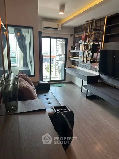 Modern living room with city view, stylish decor, and ample natural light.