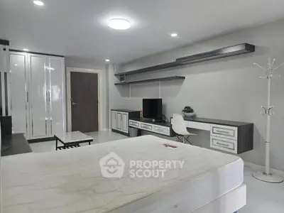 Spacious modern bedroom with sleek furniture and ample storage space