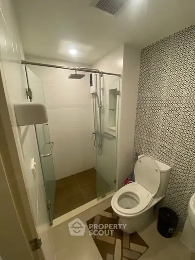 Modern bathroom with glass shower and stylish tile design