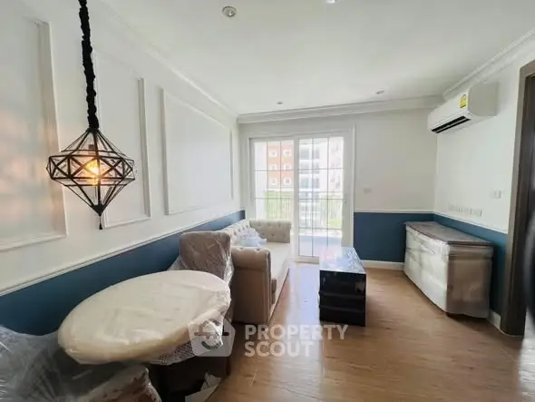 Charming living room with modern decor and natural light in a stylish apartment.