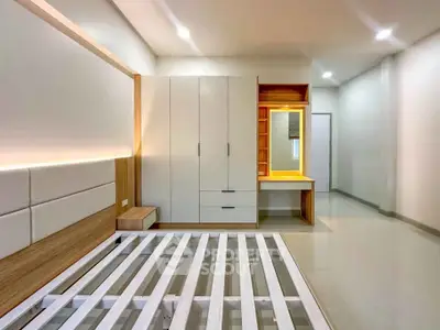 Modern bedroom with sleek wardrobe and built-in vanity in minimalist design.