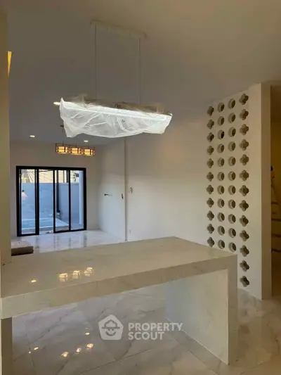 Modern interior with marble flooring and unique wall design in open layout