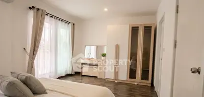 Spacious bedroom with modern decor and ample natural light
