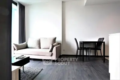 Modern living room with sleek furniture and natural light, perfect for relaxation and entertaining.