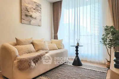 Stylish living room with cozy sofa, elegant curtains, and modern decor in a bright apartment.