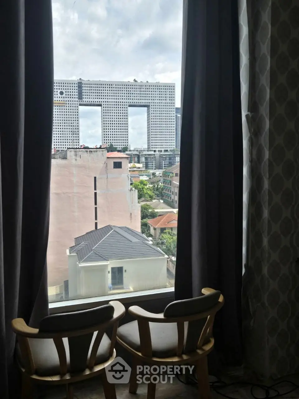 Stunning urban view from a cozy interior window with modern architecture in the background.