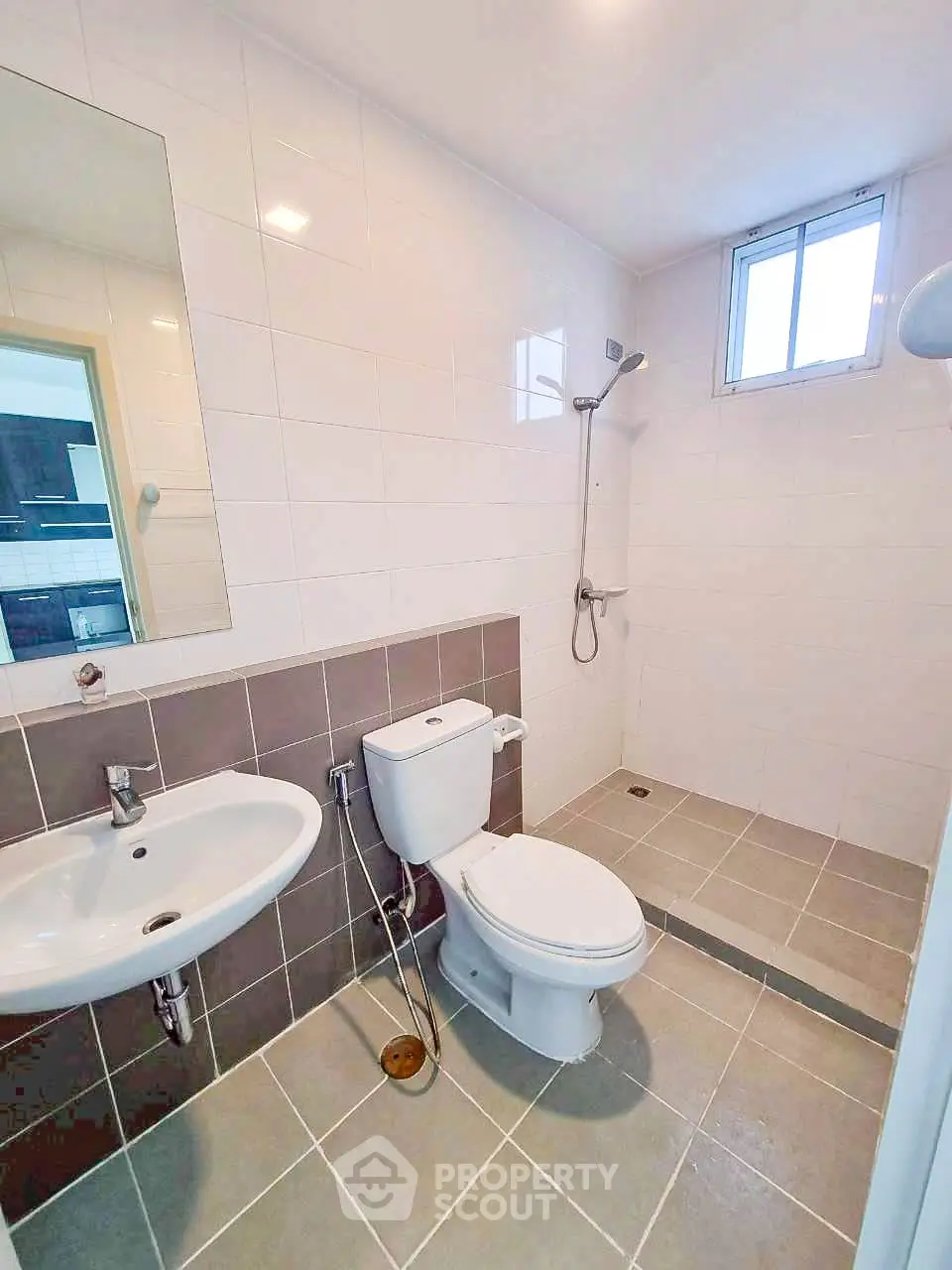 Modern bathroom with sleek fixtures and walk-in shower in a bright, tiled space.