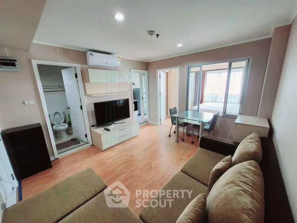 Spacious living room with modern furniture and open layout in a stylish apartment.