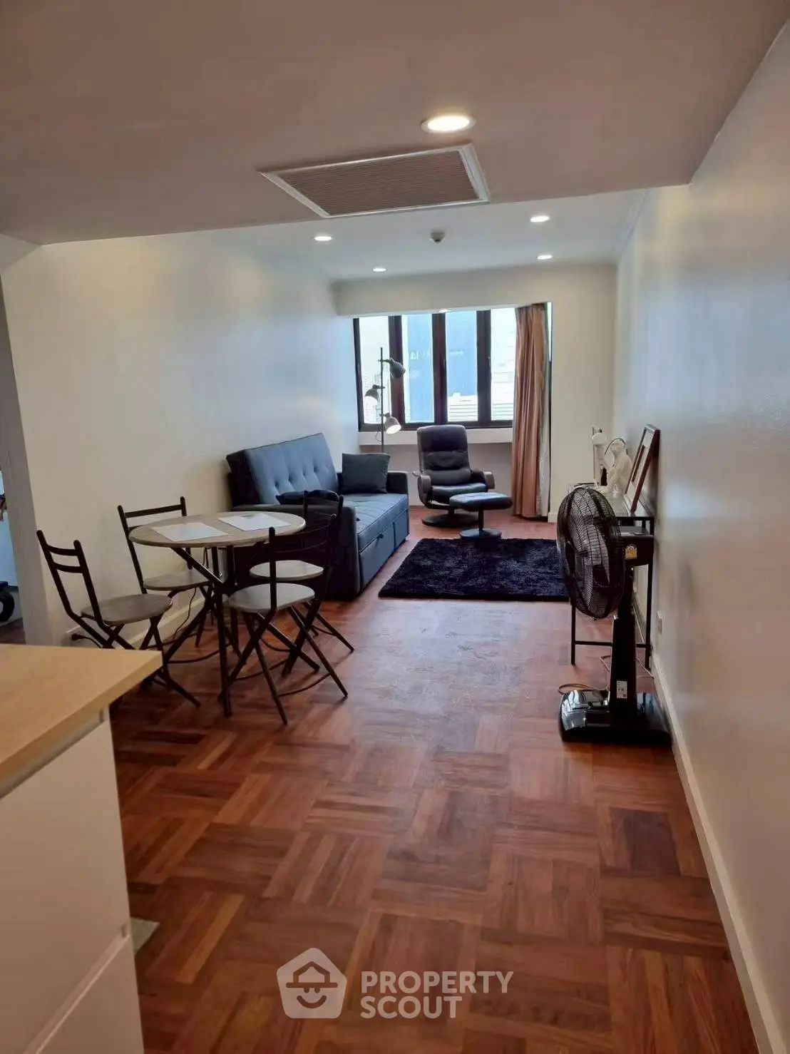 Modern living room with stylish furniture and wooden flooring, perfect for urban living.