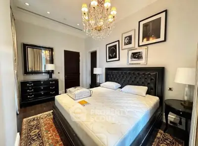 Luxurious bedroom with elegant chandelier and stylish decor