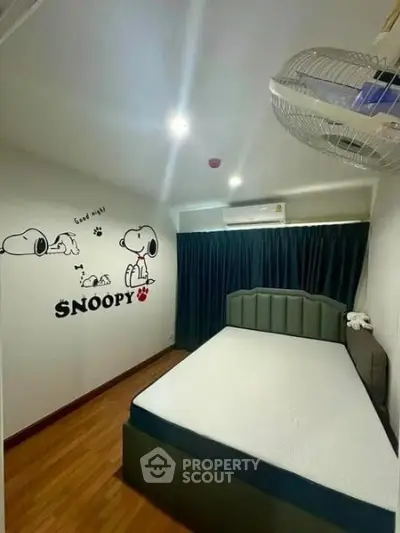 Cozy bedroom with Snoopy wall art and modern decor