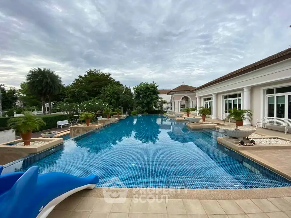 Luxurious outdoor pool area with elegant landscaping and modern architecture.