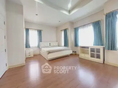 Spacious bedroom with elegant decor and natural light