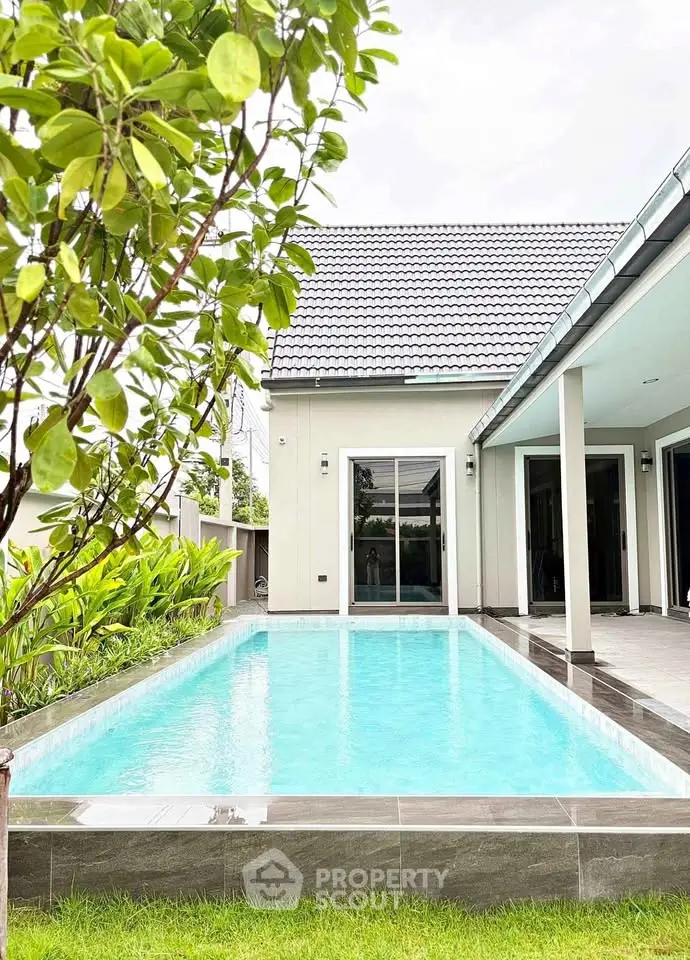 Charming modern home with inviting pool and lush garden, perfect for relaxation and entertaining.