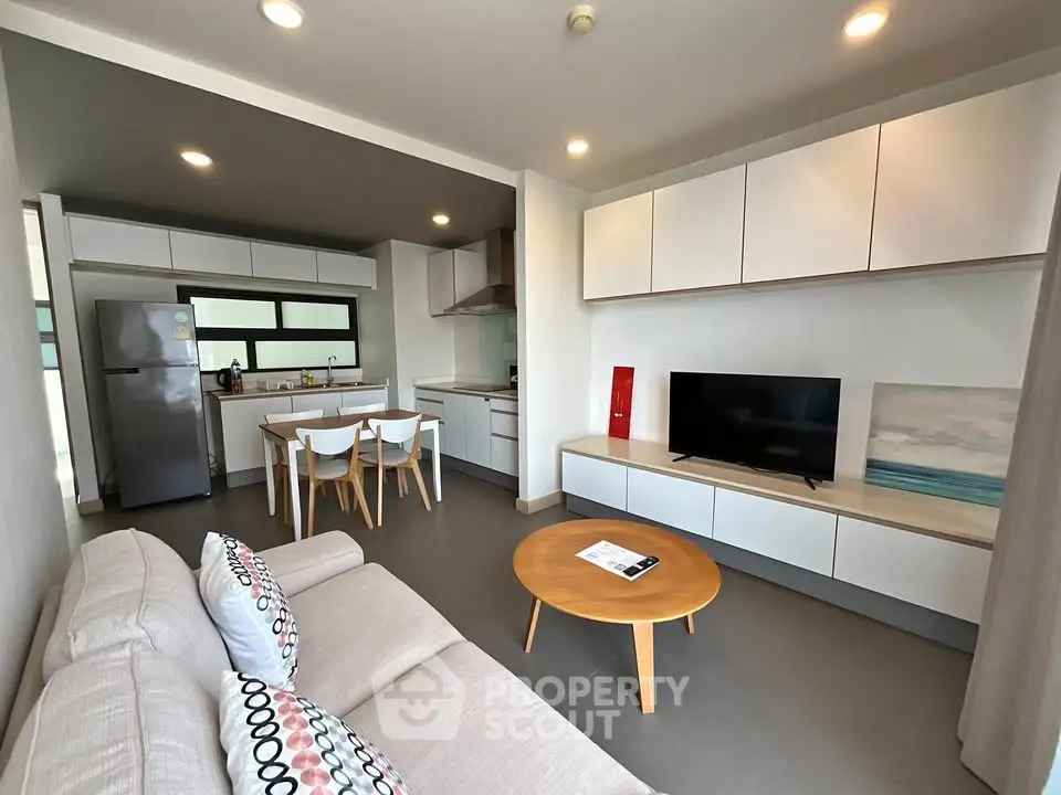 Modern open-plan living room with sleek kitchen and stylish decor