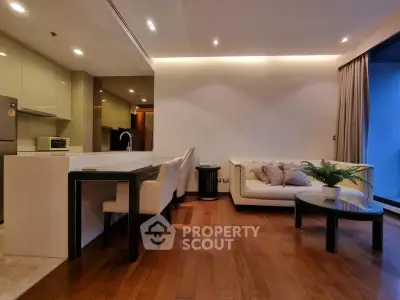 Modern open-layout living room with elegant furniture and hardwood floors