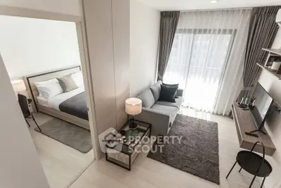 Modern apartment interior with cozy living room and adjacent bedroom, featuring stylish decor and natural light.