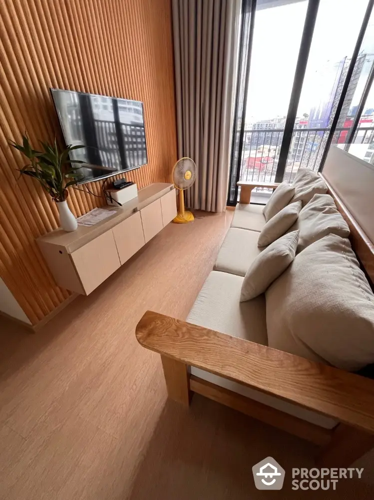 Modern living room with wooden accents and balcony view