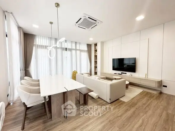 Modern living room with elegant decor, spacious seating, and stylish lighting in a contemporary apartment.