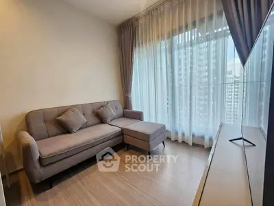 Modern living room with stylish sofa and large windows offering city views