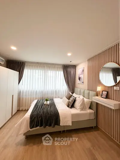 Modern bedroom with stylish decor, featuring a cozy bed, elegant curtains, and ambient lighting.